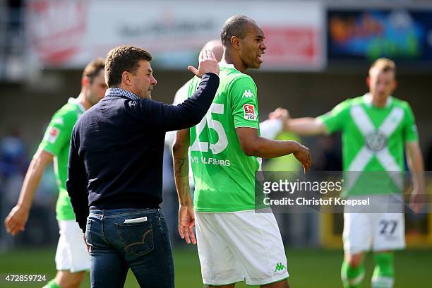 Head coach Dieter Hecking and Naldo of Wolfsburg celebrate after winning 3-1 the Bundesliga match between SC Paderborn 07 and VfL Wolfsburg at...