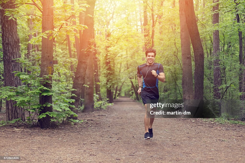 Smiling man jogging in the park