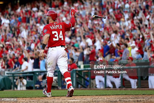 Bryce Harper of the Washington Nationals tosses his bat after hitting a walk off home run in the ninth inning against the Atlanta Braves at Nationals...