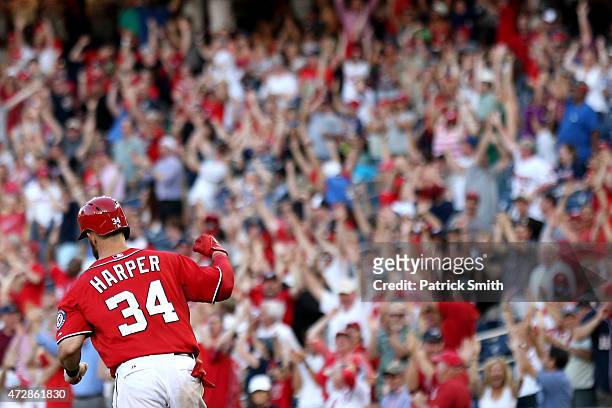 Bryce Harper of the Washington Nationals pumps his fist after hitting a walk off home run in the ninth inning against the Atlanta Braves at Nationals...