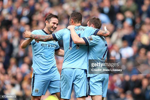Aleksandar Kolarov of Manchester City is congratulated by teammates Frank Lampard of Manchester City and James Milner of Manchester City after...