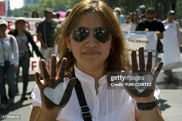 Mother takes part in a protest during the Mother's Day commemoration in Mexico City on May 10, 2015. Hundreds of mothers and relatives of missing...