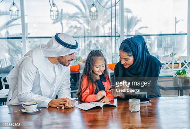 young arab family enjoying with smartphone at cafe - smart phone angle stock pictures, royalty-free photos & images