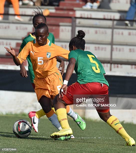 Ivory Coast's Ange Koko Nguessan vies with Cameroon's Etangue Siliki during a women friendly football match between Ivory Coast and Cameroon on May...