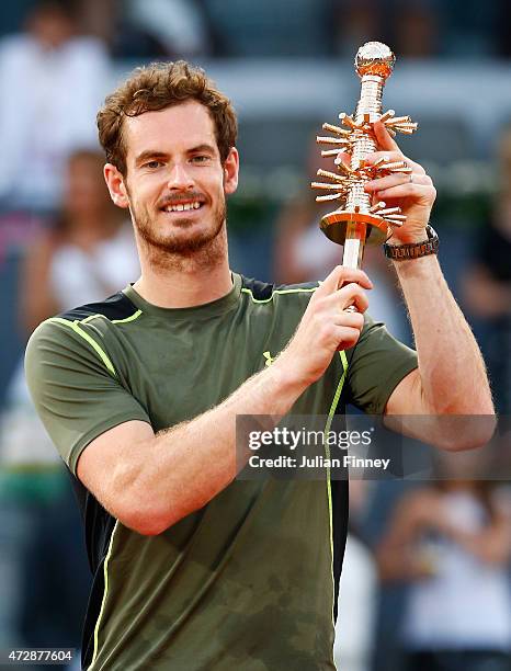 Andy Murray of Great Britain holds the winners trophy after his win over Rafael Nadal of Spain in the final during day nine of the Mutua Madrid Open...