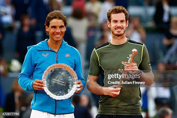 Andy Murray of Great Britain holds the winners trophy with runner up Rafael Nadal of Spain in the final during day nine of the Mutua Madrid Open...