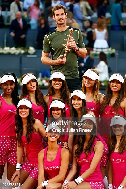 Andy Murray of Great Britain with the winners trophy along side the model ball girls after his win over Rafael Nadal of Spain in the final during day...