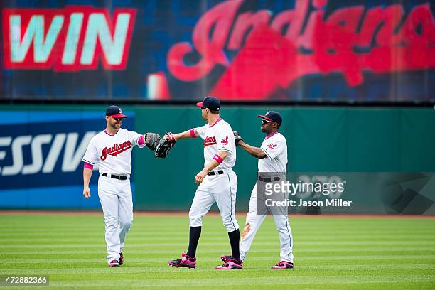 Outfielders Ryan Raburn David Murphy and Michael Bourn of the Cleveland Indians celebrate after defeating the Minnesota Twins at Progressive Field on...