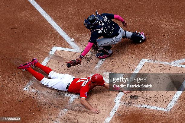 Ryan Zimmerman of the Washington Nationals slides safe at home plate as he beats the tag by catcher Christian Bethancourt of the Atlanta Braves in...