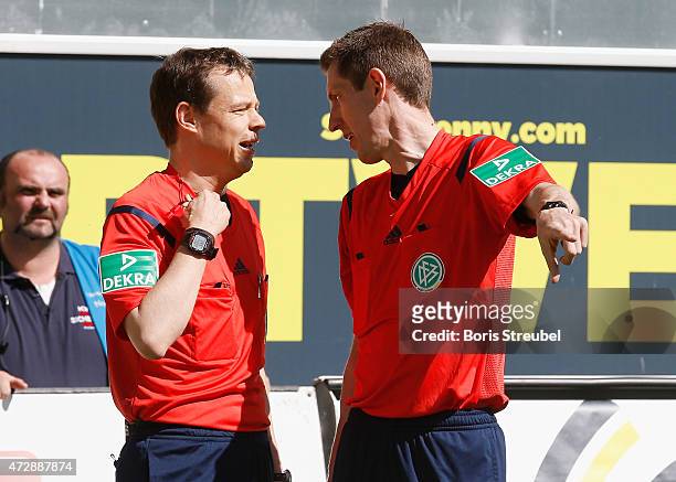 Referee Markus Schmidt talks to assistent referee Kai Voss during the Bundesliga match between SC Paderborn and VfL Wolfsburg at Benteler Arena on...
