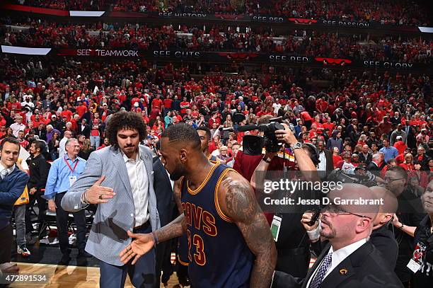 LeBron James of the Cleveland Cavaliers celebrates with his teammates after hitting the game winning shot with .7 seconds left in the game against...