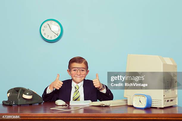 young boy businessman gives thumbs up at office - spela vuxen bildbanksfoton och bilder