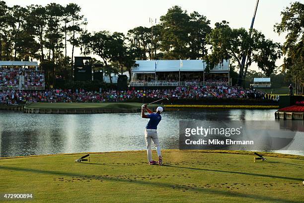 Rickie Fowler plays his shot from the 17th tee during a playoff in the final round of THE PLAYERS Championship at the TPC Sawgrass Stadium course on...