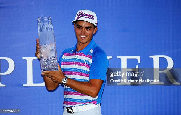 Rickie Fowler celebrates with the winner's trophy after the final round of THE PLAYERS Championship at the TPC Sawgrass Stadium course on May 10,...