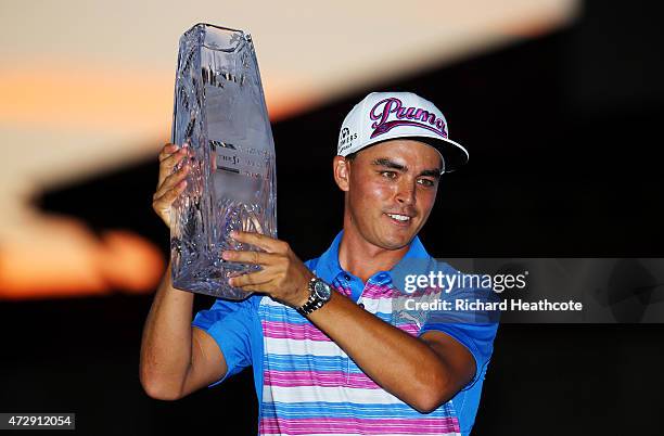 Rickie Fowler celebrates with the winner's trophy after the final round of THE PLAYERS Championship at the TPC Sawgrass Stadium course on May 10,...