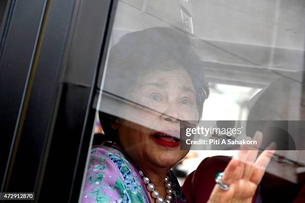 Thailand's Queen Sirikit greets people watching as she leaves Siriraj Hospital to return to her seaside palace with King Bhumibol Adulyadej....