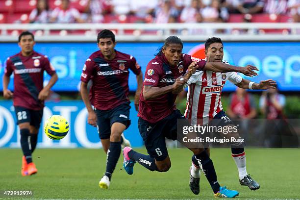 Fabian de la Mora of Chivas, fights for the ball with Joel Huiqui of Morelia, during a match between Chivas and Morelia as part of 17th round of...