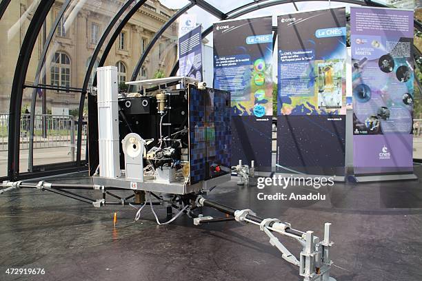 Visitors view the replica of Philae robot displayed by the French National Centre for Space Studies in front of the Grand palais in Paris on May 10,...