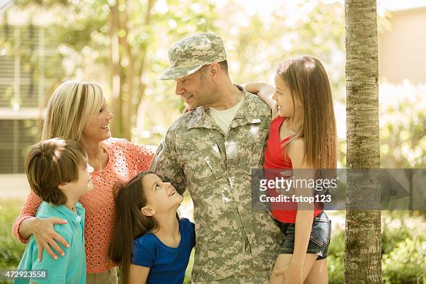 u.s. military veteran welcomed home by family. mom, children. home. - honors 2015 arrivals stock pictures, royalty-free photos & images