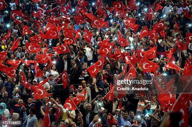 People wave Turkish flags as Turkeys President Recep Tayyip Erdogan gives a speech during an event organized by Turkish youth organizations at Ethias...