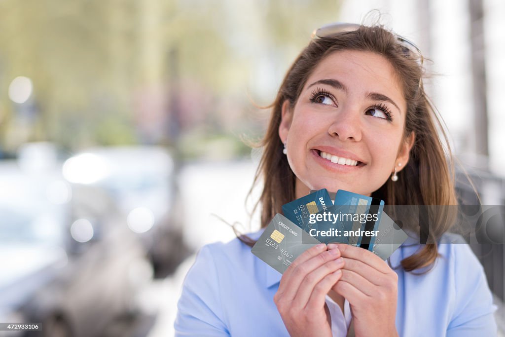 Thoughtful woman with a credit card