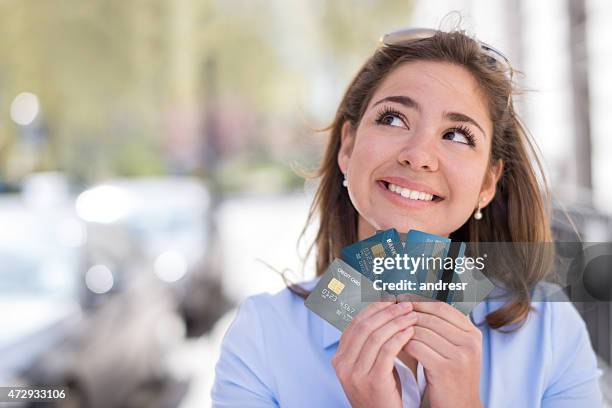 thoughtful woman with a credit card - loyalty card bildbanksfoton och bilder