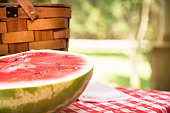 Sliced watermelon outdoors on picnic table. Summer. Basket.