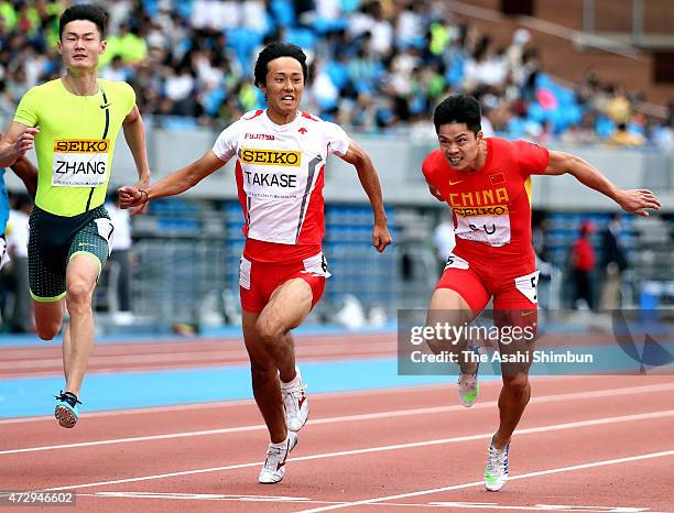 Peimeng Zhang of China, Kei Takase of Japan, and Bingtian Su of China compete in Men's 100m during the Seiko Golden Grand Prix Tokyo 2015 at Todoroki...