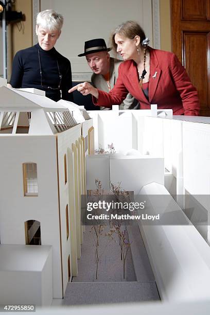 Royal Academicians Rebecca Salter, Patrick Brill aka Bob & Roberta Smith and Anne Desmet look at an architects model of the Royal Academy's...