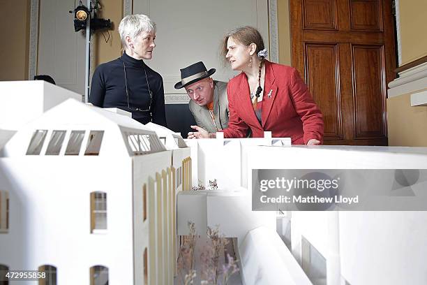 Royal Academicians Rebecca Salter, Patrick Brill aka Bob & Roberta Smith and Anne Desmet look at an architects model of the Royal Academy's...