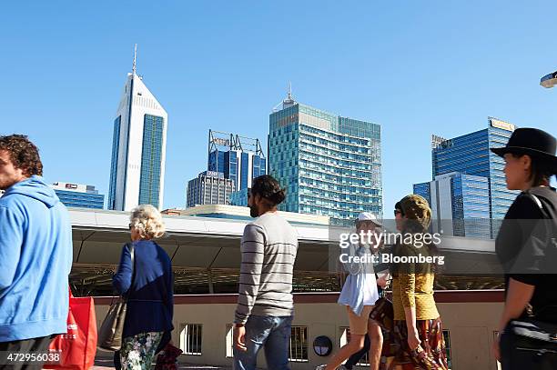 Pedestrians walk past commercial buildings in the business district in Perth, Australia, on Sunday, May 10, 2015. Prime Minister Tony Abbott's first...