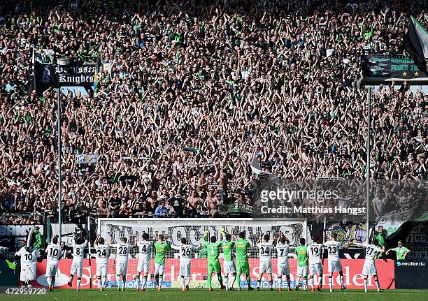 The team of Gladbach celebrate with the fans after the Bundesliga match between Borussia Moenchengladbach and Bayer 04 Leverkusen at Borussia Park...