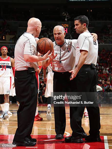 Referee Bennett Salvatore discuss a play with Joe Crawford and Zach Zarba during the game between the Atlanta Hawks and Washington Wizards in Game...