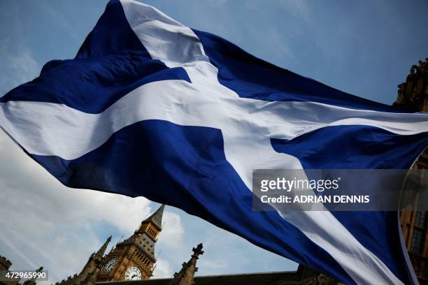 Member of public flies a giant Scottish Saltire flag outside the Houses of Parliament shortly before Scotland first minister Nicola Sturgeon posed...