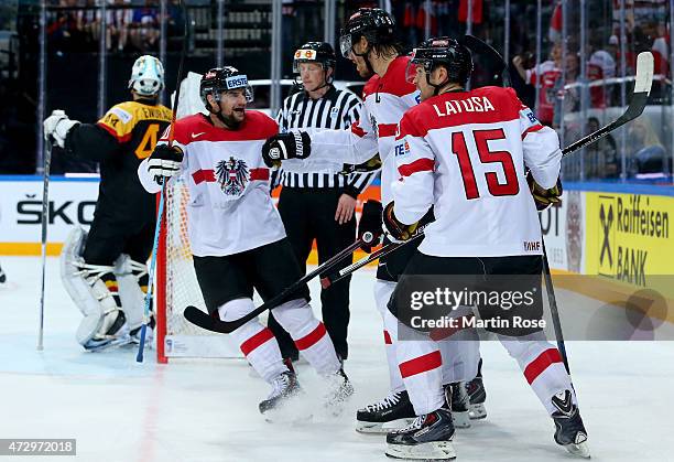 Thomas Raffl of Austria celebrate with his team mates after he scores the opening goal during the IIHF World Championship group A match between...