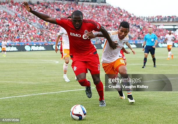 Jozy Altidore of Toronto FC battles for the ball with Luis Garrido of the Houston Dynamo during an MLS soccer game at BMO Field on May 10, 2015 in...