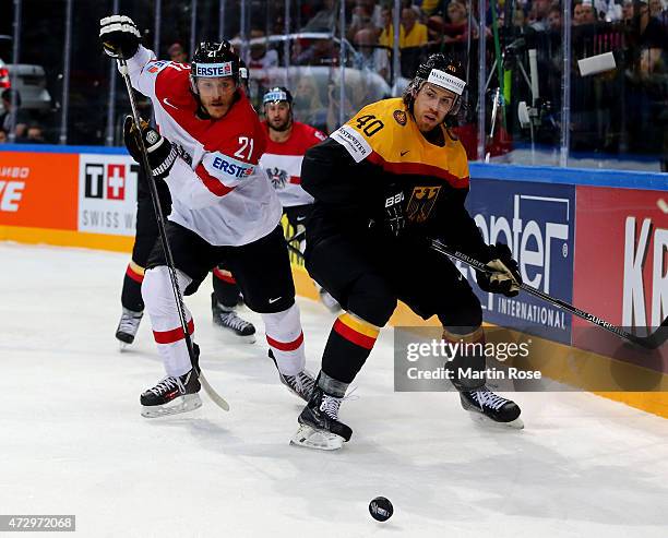 Bjoern Krupp of Germany and Manuel Geier of Austria battle for the puck during the IIHF World Championship group A match between Germany and Austria...