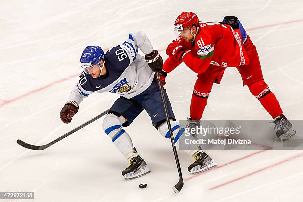 Juhamatti Aaltonen of Finland and Artur Gavrus of Belarus battle for the puck during the IIHF World Championship group B match between Finland and...