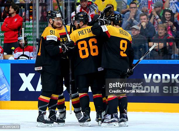 Team members of Germany celebrate their equalizing goal during the IIHF World Championship group A match between Germany and Austria at o2 Arena on...