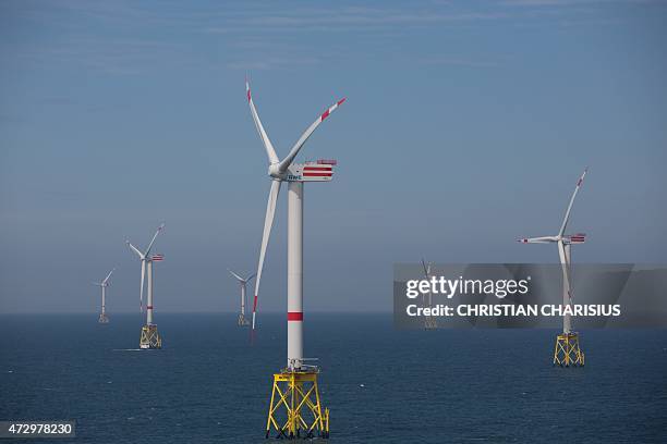 View taken on May 11, 2015 shows windmills of the "Nordsee Ost" wind park off the coast of the North Sea island of Helgoland, northern Germany. The...