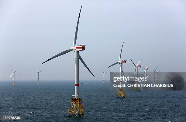 View taken on May 11, 2015 shows windmills of the "Nordsee Ost" wind park off the coast of the North Sea island of Helgoland, northern Germany. The...