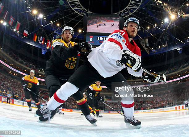 Daniel Pietta of Germany and Manuel Geier of Austria battle for the puck during the IIHF World Championship group A match between Germany and Austria...