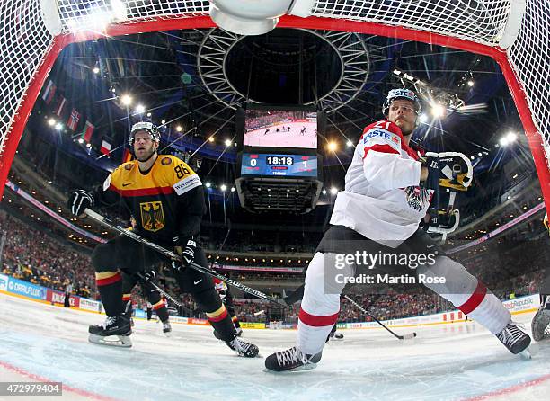 Daniel Pietta of Germany and Manuel Geier of Austria battle for the puck during the IIHF World Championship group A match between Germany and Austria...