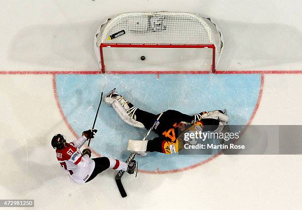 Konstantin Komarek of Austria scores a goal over Dennis Endras, goaltender of Germany during the IIHF World Championship group A match between...