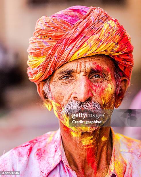 senior indian man celebrating holi festival - holi portraits stock pictures, royalty-free photos & images