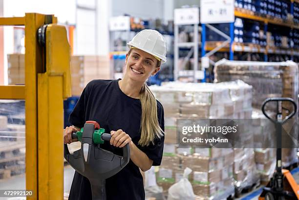 woman driving pallet truck - pallet jack stock pictures, royalty-free photos & images