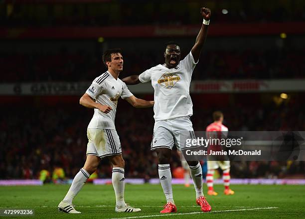 Bafetimbi Gomis of Swansea City celebrates scoring the opening goal with Jack Cork of Swansea City during the Barclays Premier League match between...