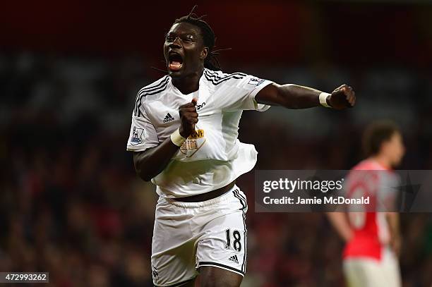 Bafetimbi Gomis of Swansea City celebrates scoring the opening goal during the Barclays Premier League match between Arsenal and Swansea City at...
