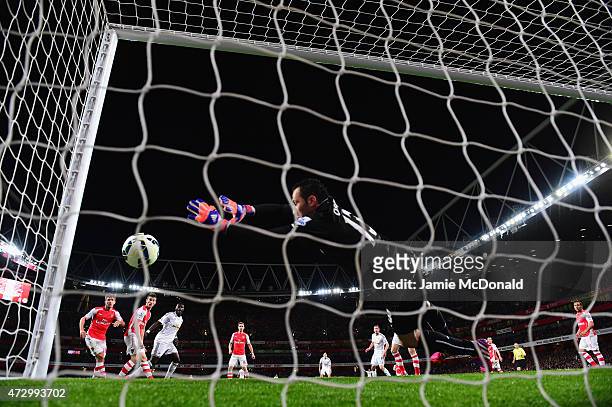 Bafetimbi Gomis of Swansea City scores the first goal as goal line technology rules the ball to cross the line depsite David Ospina of Arsenal making...