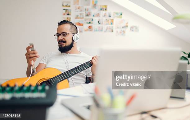 musician composing music in his recording studio. - song writer stock pictures, royalty-free photos & images